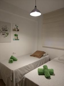 מיטה או מיטות בחדר ב-Apartamento Málaga Picasso