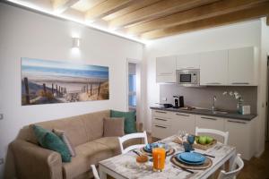 a living room with a couch and a table at Le Dimore Di Puglia - Palazzo Pinto in Monopoli +65 photos