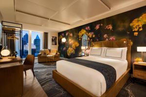 a bedroom with a large bed and a living room at EXchange Hotel Vancouver in Vancouver +37 photos