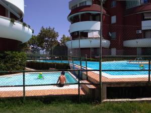 a swimming pool with people in the water at Casa de Diego in Francavilla al Mare
