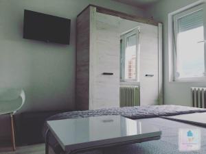 a bedroom with a bed with a tv on the wall at 3M Apartment Skopje Center in Skopje