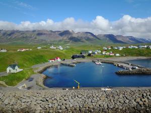 an aerial view of a harbor with a small town at Fraendgardur in Hofsós