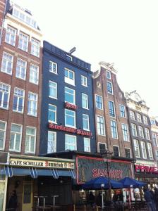 a large building on a city street with tall buildings at Rembrandt Square Hotel in Amsterdam
