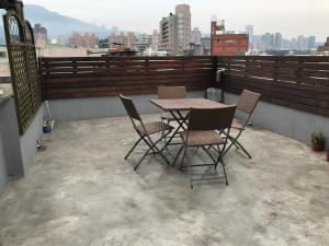 a table and chairs sitting on a balcony at Tourist Bunny Hostel in Tamsui +38 photos