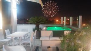 a rooftop patio with a pool and a table and chairs at B&B Alle Calende Greche in Martignano