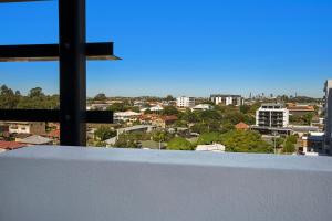 a tall building with a view of a city at The Chermside Apartments in Brisbane