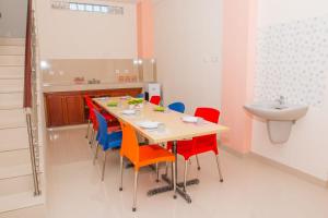 a dining room with a table and chairs and a sink at Berlian Hotel in Ende