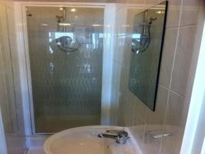 a bathroom with a sink and a shower at City Inn Express Hotel in London