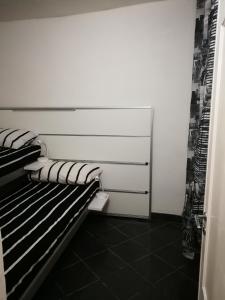 a room with a black and white bed in a room at inside my city in Genoa