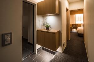 Postel nebo postele na pokoji v ubytování Tomoya Residence Hotel Kyoto