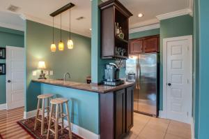 a kitchen with blue and green walls and bar stools at Rick's Downtown Nashville Guest House in Nashville