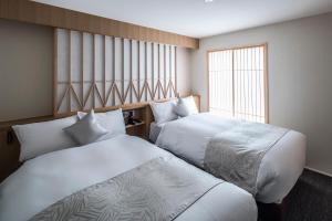 Postel nebo postele na pokoji v ubytování Tomoya Residence Hotel Kyoto