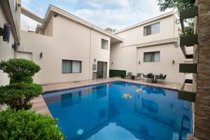 a swimming pool in front of a building at Antaris Valle in Monterrey