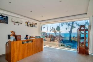 a shop with a counter with a large window at Blue Marine Resort in Gili Air