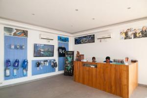 a man sitting at a counter in a store at Blue Marine Resort in Gili Air