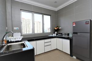 a kitchen with a sink and a refrigerator at Setapak, wangsamaju to KLCC & PWTC 171 in Kuala Lumpur