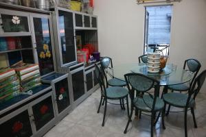 a dining room with a glass table and chairs at Homestay Tanjung Duata Bohe Silian in Maratua Atoll