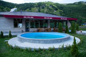 a large swimming pool in front of a building at Jermuk Verona Resort in Jermuk