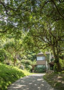 a road leading to a house with trees at Crossing The Rainbow Bridge B&B in Chongde