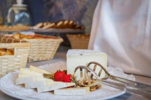 a plate of cheese and strawberries on a table at Mediterraneo Emotional Hotel & Spa in Santa Margherita Ligure