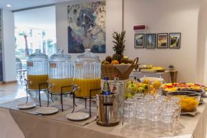 a table with glasses and bottles of orange juice at Mediterraneo Emotional Hotel & Spa in Santa Margherita Ligure
