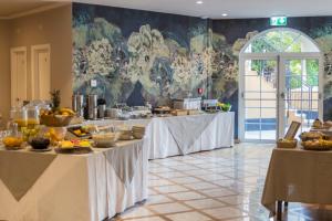 a kitchen with two tables with food on it at Mediterraneo Emotional Hotel & Spa in Santa Margherita Ligure