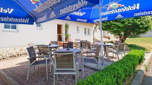 a group of tables and chairs under umbrellas at Motel Hormersdorf in Hormersdorf