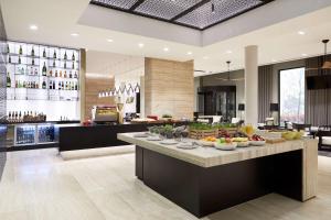 a kitchen with a buffet of food on a counter at Hyatt Place Melbourne Essendon Fields in Melbourne