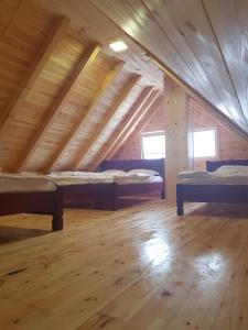 a room with three beds in a attic at Apartmani Prisoje in Žabljak
