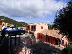 a car parked in a parking lot next to a house at B&B Simon&Simon in San Teodoro