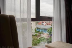 a window with a view of a city at Green Hadong Hotel in Hà Ðông