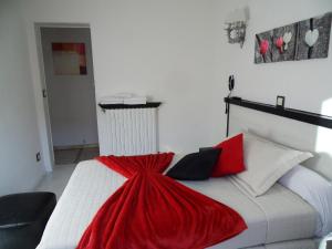 a bedroom with a bed with a red blanket on it at Camelia Prestige - Place de la Nation in Paris