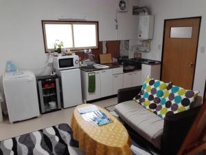 a kitchen with a couch and a table in a room at Corpo Marika A in Hakodate