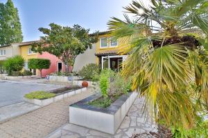 a house with a palm tree in front of it at Hotel Le Coudon in La Farlède