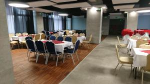 a dining room with tables and chairs and red and white tables at Apartamenty Sportowe AWF in Katowice