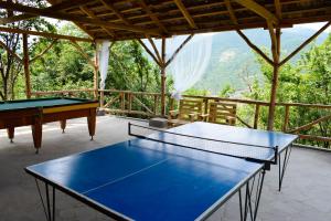 two ping pong tables on a patio with a view at Verin Tun in Dilijan
