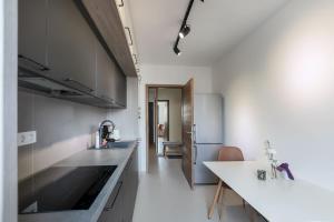 a kitchen with white counters and stainless steel appliances at Warm Amber Suites Brașov in Braşov +82 photos
