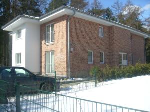 a brick building with a car parked in front of it at Arkadia Haus Alstertal in Hamburg