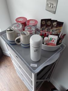 a table with cups and other items on it at Byers Guest house in Banavie