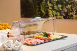 a tray of food on a table with a plate of food at Pension Lichtenburg in Nalles