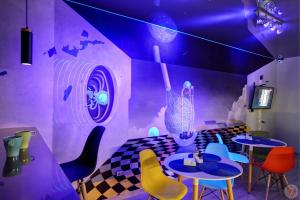 モスクワにあるHostel Bratislavskayaの紫の天井の客室で、テーブルと椅子が備わります。