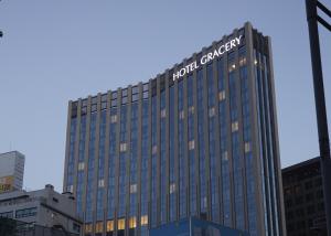 a tall building with the hotel cancer sign on it at Hotel Gracery Seoul in Seoul