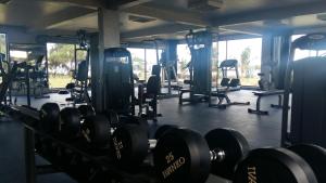 a gym with lots of dumbbells in a room at Retaj Moroni in Moroni