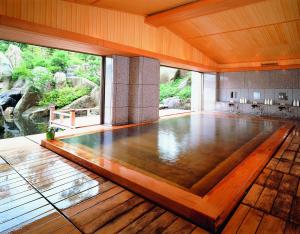 an empty dance floor with a view of a river at PittINN in Goshogawara