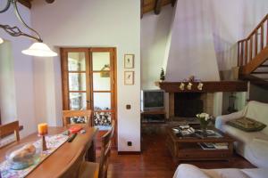 uma sala de estar com um sofá e uma mesa em H4, Bordes d'Arinsal, Triplex Rustico con chimenea, Arinsal, Zona vallnord em Mas de Ribafeta