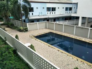 a swimming pool on the balcony of a building at Lomsabai Apartments in Bangsaen