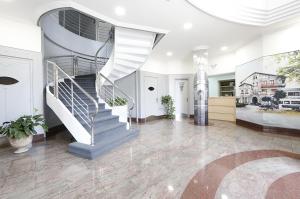 a lobby with a spiral staircase in a building at Hotel Loiola in Azpeitia