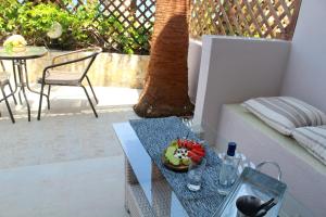 a table with a bowl of vegetables on a patio at Bel Momento in Alikanas