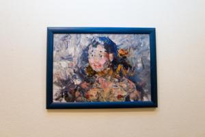 a framed painting of a woman on a wall at Nice Flats Smolenskaya in Moscow