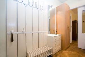 a dressing room with white cabinets and a mirror at Nice Flats Smolenskaya in Moscow